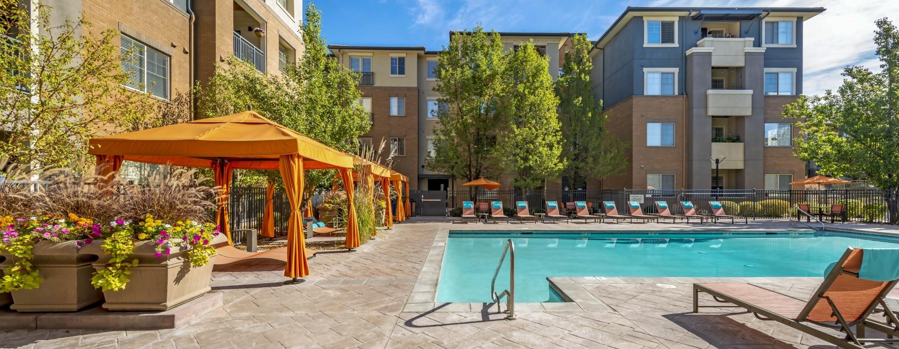 cabanas alongside outdoor swimming pool