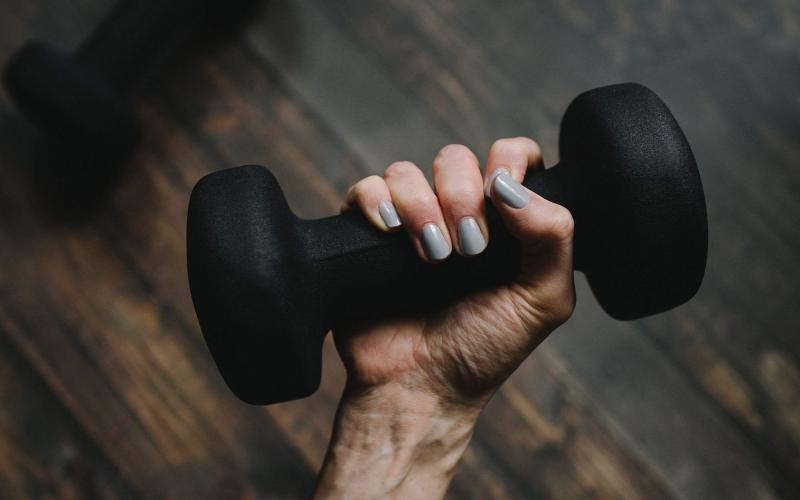 a person's hand holding a dumbbell