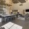 a large kitchen with a bar and chairs in clubhouse