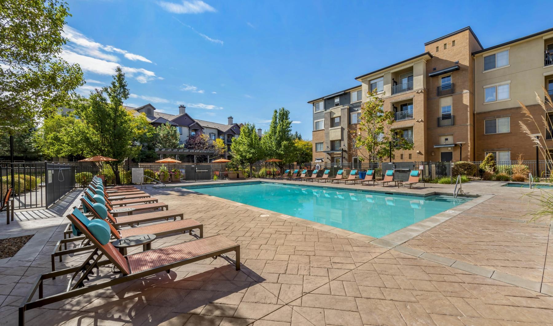 a pool with lounge chairs around it